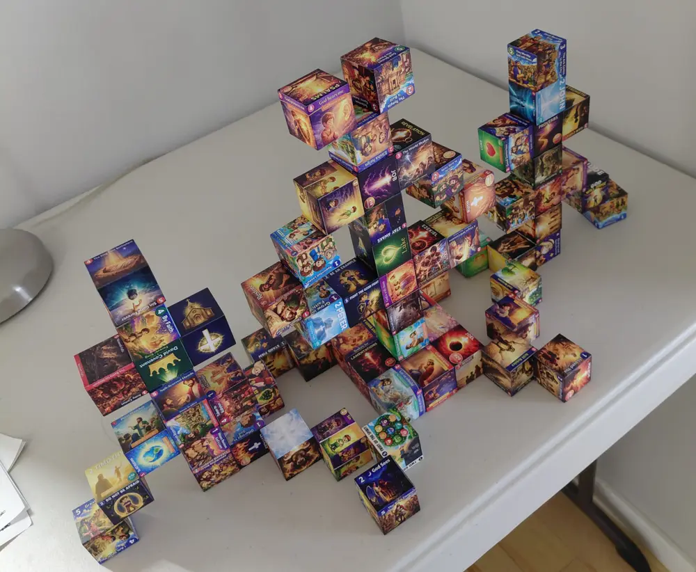 Kids-style build made from dozens of illustrated Kingdom Cubes magnetic blocks stacked into towers on a table